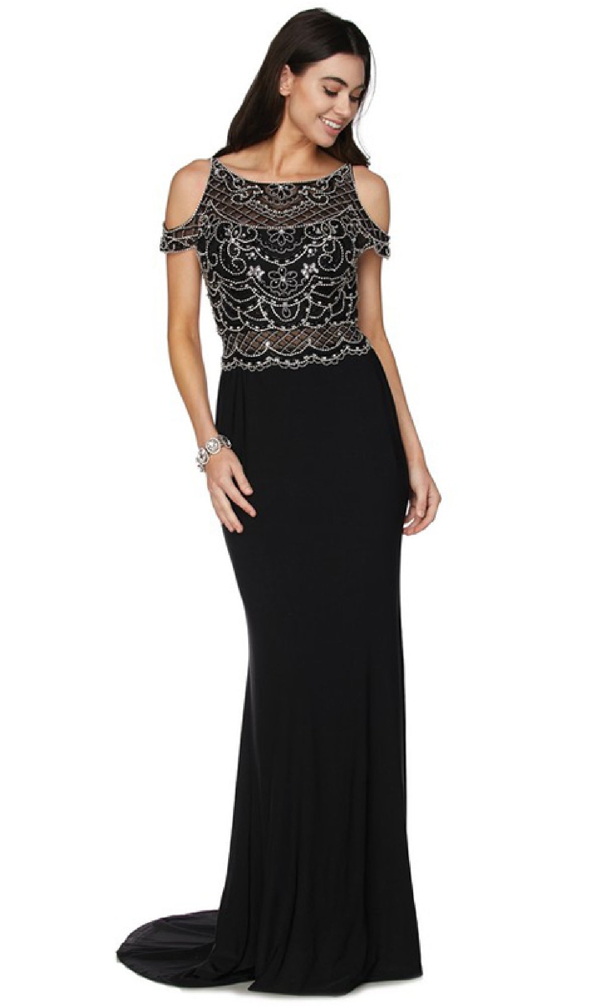 Woman wearing the Juliet 660 Long Prom Dress, featuring a form-fitting black design with a beaded bodice and short cold shoulder sleeves, standing and smiling.